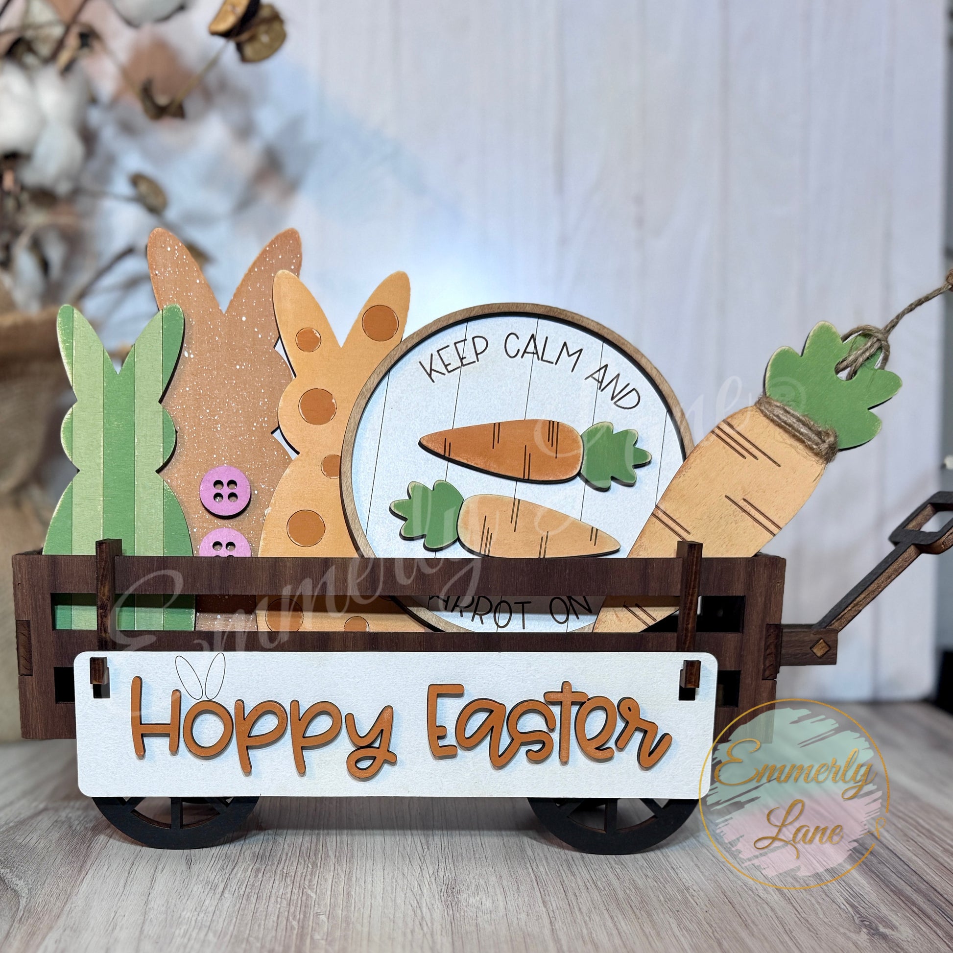 A handcrafted wooden Easter shelf sitter kit featuring a banner with the text 'Hoppy Easter', a round sign, a carrot, and three bunnies attached together, displayed in a wagon.